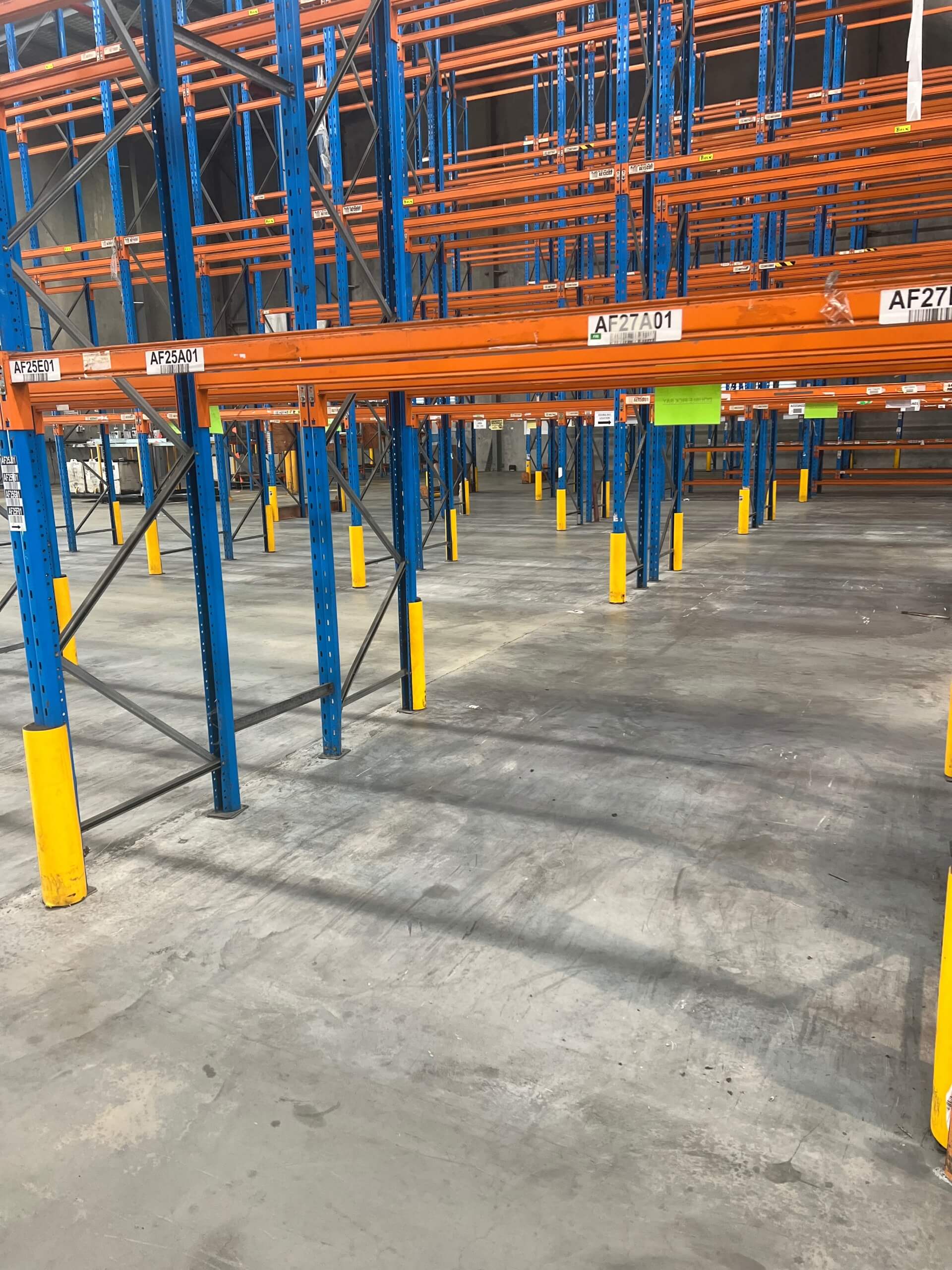 Warehouse racking with orange beams and blue supports
